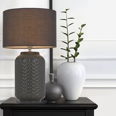 two vases and a lamp on a table