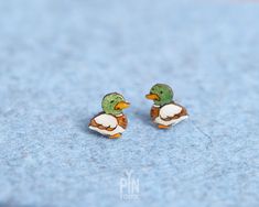 "✨ Duck earrings measuring only 1 x 0.8 cm ✨ This cute mallard ducks are crafted from wood with a stainless steel base ✨ Those funky earrings are processed within 1-3 business days 🦆🌿 Embrace the beauty of nature with our mallard duck funky earrings! 🦆🌿 These cool bird earrings are a charming addition to any outfit, whether you're a nature enthusiast, a duck hunter, or simply a lover of quirky accessories. Crafted with attention to detail, each earring features an adorable mallard duck design, capturing the spirit of these magnificent birds in a fun and stylish way. 🌈🦆 Measuring 1x0.8 cm (3/8\" x 1/4\"), these studs are small and lightweight, making them comfortable to wear throughout the day. Made with high-quality materials, these funky earrings are both stylish and safe for kids a Fun Earrings Studs, Duck Themed Gifts, Duck Accessories, Cute Earrings Studs, Silly Earrings, Duck Earrings, Quirky Accessories, Mallard Ducks, Earrings Cool