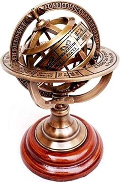 an antique brass plated globe on a wooden stand