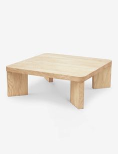 a wooden coffee table with no legs on the bottom and one leg raised up to the side