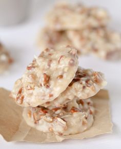 three cookies are stacked on top of each other with white frosting and walnuts