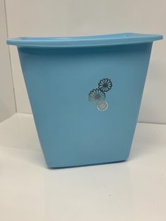 a blue flower pot sitting on top of a white table