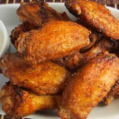 chicken wings with dipping sauce on the side