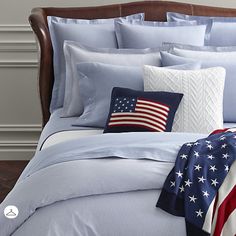 an american flag blanket and pillows on a bed