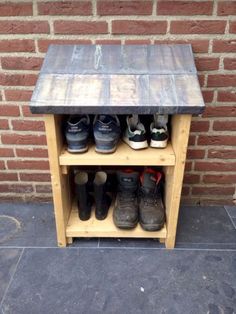 several pairs of shoes are lined up on a shelf in front of a brick wall