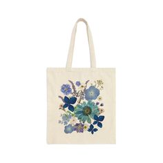 This 100% cotton bag comes in one size - 15" x 16"- perfect for everyday wear. While the canvas material is durable and will last for years. The bag features 20" handles (made from the same canvas), making it easy to carry even with a week's worth of shopping. 100% cotton canvas Heavy fabric (12 oz/yd² (406.9 g/m Sewn-in label Botanical Canvas Bags For Everyday Use, Botanical Cotton Tote Bag, Botanical Style Canvas Bags For Everyday Use, Botanical Style Cotton Tote Bag, Botanical Cotton Canvas Bag For Daily Use, Botanical Cotton Canvas Bag For Everyday Use, Botanical Cotton Canvas Tote Bag, Botanical Cotton Bags As A Gift, Botanical Cotton Bags As Gift