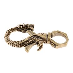 an antique brass dragon bottle opener on a white background