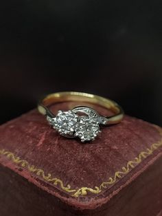 a diamond ring sitting on top of an old book