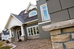 a gray house with white trim and windows