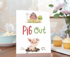 a pig out card sitting on top of a table next to cupcakes