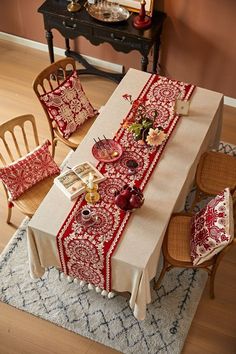 the table is covered with a red and white table cloth, which has been placed on top of a rug