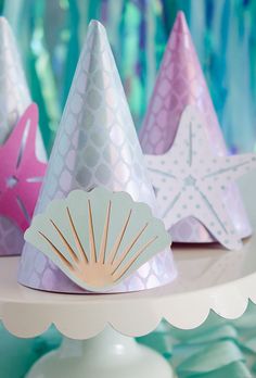 three party hats with seashells and starfish on them