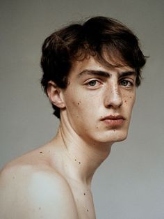 a young man with freckles on his chest