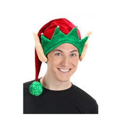 a man wearing a green and red elf's hat with two horns on his head