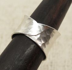 "Handmade Hammered Sterling Silver wide concave band Ring, Adjustable Wrap Band, Shiny finish *Width (top side): 9/16 inches (0.6\") / 1.5cm Metal Purity: 95% Silver (Purer than 925 Sterling Silver) Wider version (1.1\" / 2.8cm): https://www.etsy.com/listing/185404378 Medium version (0.85\" / 2.1cm): https://www.etsy.com/listing/578056282 We also have Matching style Cuffs: https://www.etsy.com/listing/256824170 https://www.etsy.com/listing/173665269 To browse some more of our Silver Jewelry coll Handmade Wide Band Ring For Promise, Adjustable Thick Band Sterling Silver Ring, Handmade Adjustable Wide Band Promise Ring, Adjustable Thick Band Wide Ring Gift, Adjustable Thick Band Wide Ring As Gift, Adjustable Wide Band Ring For Anniversary, Adjustable Wide Band Ring Gift, Adjustable Open Ring Metal Band, Adjustable Open Metal Ring Band