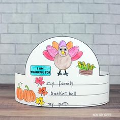 a paper turkey hat that says, i am thanksgiving for my family basket ball my pets