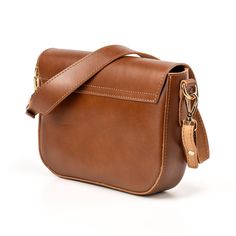 This women's shoulder bag combines style and functionality, perfect for every occasions. The modern design is enriched by a brass swivel lock, which adds a touch of elegance, allowing you to keep your personal belongings safe. The shoulder strap ensures optimal comfort, fitting perfectly around it. This bag is the ideal accessory to complete every outfit with style. Made with Vegetable Tanned Leather  Fashion Design for every kind of Elegance Vegetable Tanned Leather Brown Hand-tooled Crossbody Shoulder Bag, Brown Crossbody Evening Bag With Gold-tone Hardware, Brown Buckle Closure Crossbody Satchel, Brown Crossbody Bucket Bag With Gold-tone Hardware, Brown Crossbody Bag With Silver-tone Hardware, Poems Beautiful, August Birthstone Jewelry, July Birthstone Jewelry, Women Accessories Bags