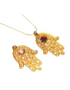 "Beautiful large gold plated Hamsa charm necklaces to choose from. Flower and stone can be ordered at a different color so if you have one in mind just let me know. Approx size 1 3/4\" long and 1 1/4\" wide Since the Hamsa hand is considered a gift of love it makes the perfect gift idea. The Hamsa hand is a symbol that's been around for thousands of years and is believed to protect and shield against the evil eye, generate positive energy, provide good fortune, health, prosperity and happiness. Gold Plated Amulet Necklace For Blessing, Gold Plated Charm Necklaces With Large Pendant, Gold Evil Eye Pendant Charm Necklace, Gold Spiritual Crystal Necklaces Nickel Free, Nickel-free Gold Plated Spiritual Necklaces, Traditional Gold Necklaces With Charms, Traditional Gold Necklace With Charms, Gold Evil Eye Jewelry For Blessing, Gold Amulet Pendant Crystal Necklaces