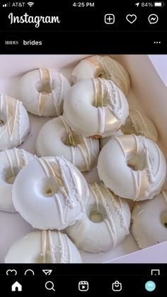 a box filled with white donuts covered in frosting