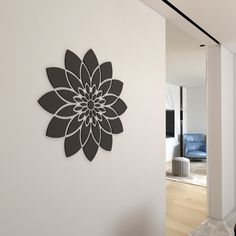 a large metal flower is mounted on the wall