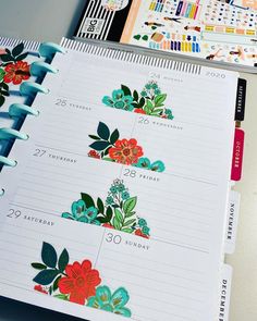 an open planner with colorful flowers on it