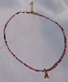 Add a burst of color to your wardrobe with this vibrant Personalized Rainbow Seed Bead Necklace. Thoughtfully handcrafted to celebrate individuality, this necklace features an array of multicolored seed beads, customizable with a name or word of your choice. Each bead is carefully selected to create a lively, eye-catching design that adds a fun and personal touch to any outfit. Why You'll Love It: Vibrant Multicolors: Each necklace is made with bright, multicolored seed beads, creating a striking rainbow effect that's sure to turn heads. Personalized Charm: Customize your necklace with a name, word, or initials, making it a truly unique and meaningful accessory. Handcrafted Quality: Meticulously handcrafted with care and precision, ensuring a durable and high-quality piece that you can che Multicolor Letter Beads Jewelry, Multicolor Letter Beaded Jewelry, Colorful Heart Beads Necklaces For Festivals, Colorful Heart Beads Necklace For Festivals, Colorful Festival Necklaces With Heart Beads, Colorful Bohemian Beaded Necklaces With Heart Beads, Multicolor Heart Beaded Necklaces With Round Beads, Colorful Beaded Necklaces With Letter Beads For Jewelry Making, Colorful Letter Beads Jewelry For Festivals