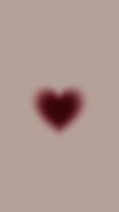 a heart shaped object is shown in the middle of a blurry image with red light