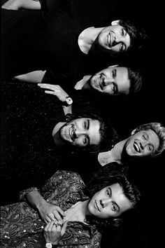 four men are posing for a black and white photo