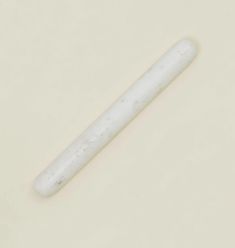 a white toothbrush sitting on top of a table