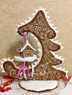 a gingerbread christmas tree is decorated with icing