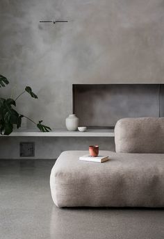 a living room with a couch, coffee table and potted plant