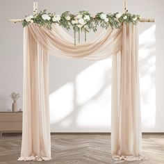 a wedding arch decorated with flowers and greenery