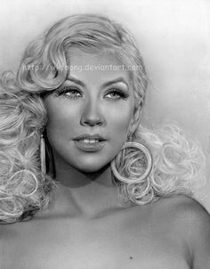 a black and white photo of a woman with blonde hair wearing large hoop earrings on her head