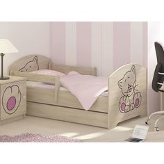 a child's bedroom with pink and white striped wallpaper, wooden furniture and teddy bear bedding