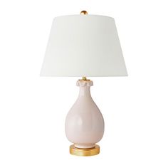 a white lamp with a gold base and a white shade on the top of it