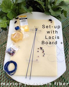 the table is covered with crafting supplies such as wire, beads and flowers on it