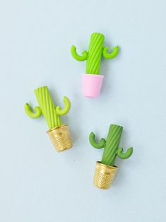 three green cactus shaped objects sitting next to each other