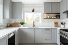 a kitchen with gray cabinets and white counter tops