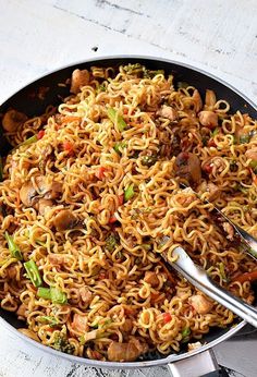 a skillet filled with noodles and vegetables