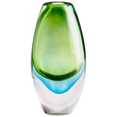 a green and blue vase sitting on top of a white table