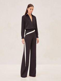 Elevate your ensemble with the Roks Pants, where tailored sophistication meets modern flair. These pants are cut to perfection, offering a flattering high-rise waist and a fluid wide-leg silhouette that promises to streamline any look. The sleek side stripe detail adds a contemporary edge. Versatile in design, they can be seamlessly paired with the structured elegance of the Morison Top or the relaxed refinement of the Libra Dress. Model wears XS. Libra Dress, Flair Pants, Right To Privacy, Skirt Jumpsuit, Side Stripe, In Design, Model Measurements, Jacket Tops, Black Pants