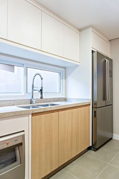 a kitchen with stainless steel appliances and wooden cabinets