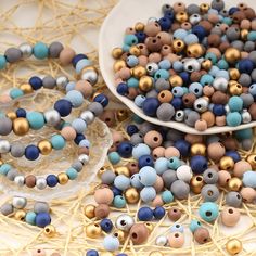 several different beads on a table next to a plate