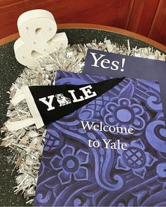 a welcome sign is placed on top of a table with tinsel and paper decorations