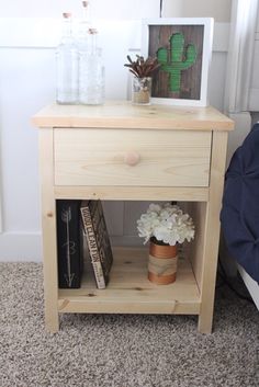 a small wooden table with flowers and books on it