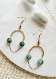 "These are long, beaded, brass arch earrings featuring 10mm African Turquoise beads, brass chain, and rectangular Dalmatian Jasper beads. These unique boho earrings hang approximately 3.25\" inches from the lobe. The earwire is 18k gold plated and should be suitable if you have a metal allergy or sensitivity. These earrings are very lightweight and easy to wear. If you are not satisfied with your purchase, contact me within 14 days, and return your earrings in the original packaging for a full r Diy Boho Earrings, Boho Earrings Diy, Beaded Chandelier Earrings, Arch Earrings, Beaded Earrings Tutorials, Beaded Earring, Bar Jewelry, Beaded Jewlery, Wrapped Earrings