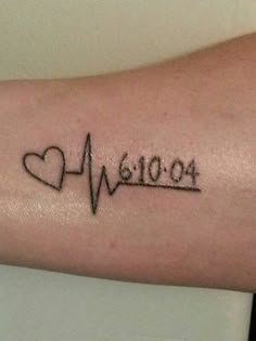 a person with a heart and heartbeat tattoo on their arm that says love 1010