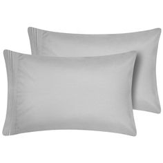 two white pillows and one light gray pillow