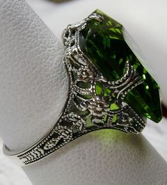 Classic Green Jewelry With Jewels, Classic Green Jeweled Jewelry, Classic Green Jewelry With Vs Clarity, Green Peridot Crystal Ring For Weddings, Elegant Green Crystal Ring With Accent Stones, Classic Green Crystal Ring For Formal Occasions, Green Gemstone Filigree Ring For May Birthstone, Vintage Green Crystal Ring For Anniversary, Elegant Green Peridot Crystal Ring