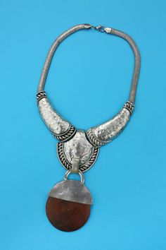 "Large Statement Vintage Boho Necklace in Silver with Wood Pendant with Snake Chain Hangs 12.5\" long Pendant is 2.5 x 2.75\" Condition: 2 Condition Scale: 1-Immaculate Vintage Condition (Rare) 2-Unnoticeable Vintage Wear or Spots that are unphotographable 3-Small Noticable Vintage Wear or Spots, as photographed 4-A Lot of Noticable Vintage Wear or Spots, as photographed 5-Needs Repair or Work" Nickel Free Brown Metal Necklace, Nickel-free Brown Metal Necklace, Brown Nickel-free Metal Necklace, Wood Pendant, Long Pendant, Novelty Print, Vintage Wear, Boho Necklace, Snake Chain